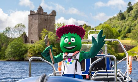 Team Scotland mascot Clyde with the Baton on Loch Ness