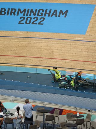 Riders lie on the track following a massive crash during the men's 15km scratch race qualifying round cycling event on day three of the Commonwealth Games, at the Lee Valley VeloPark