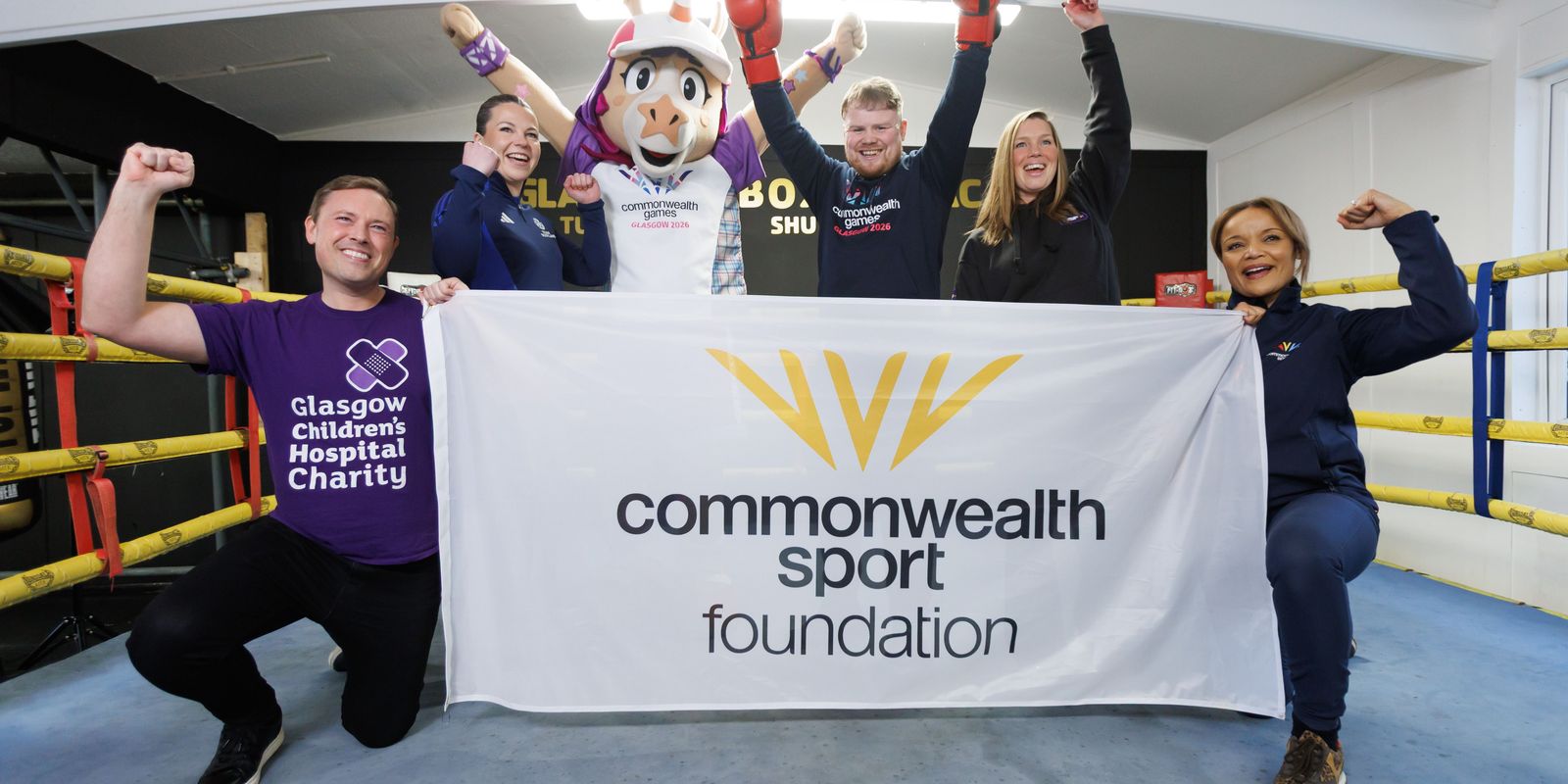 Finnie and Charlie Flynn with representatives from Glasgow 2026 charity partners